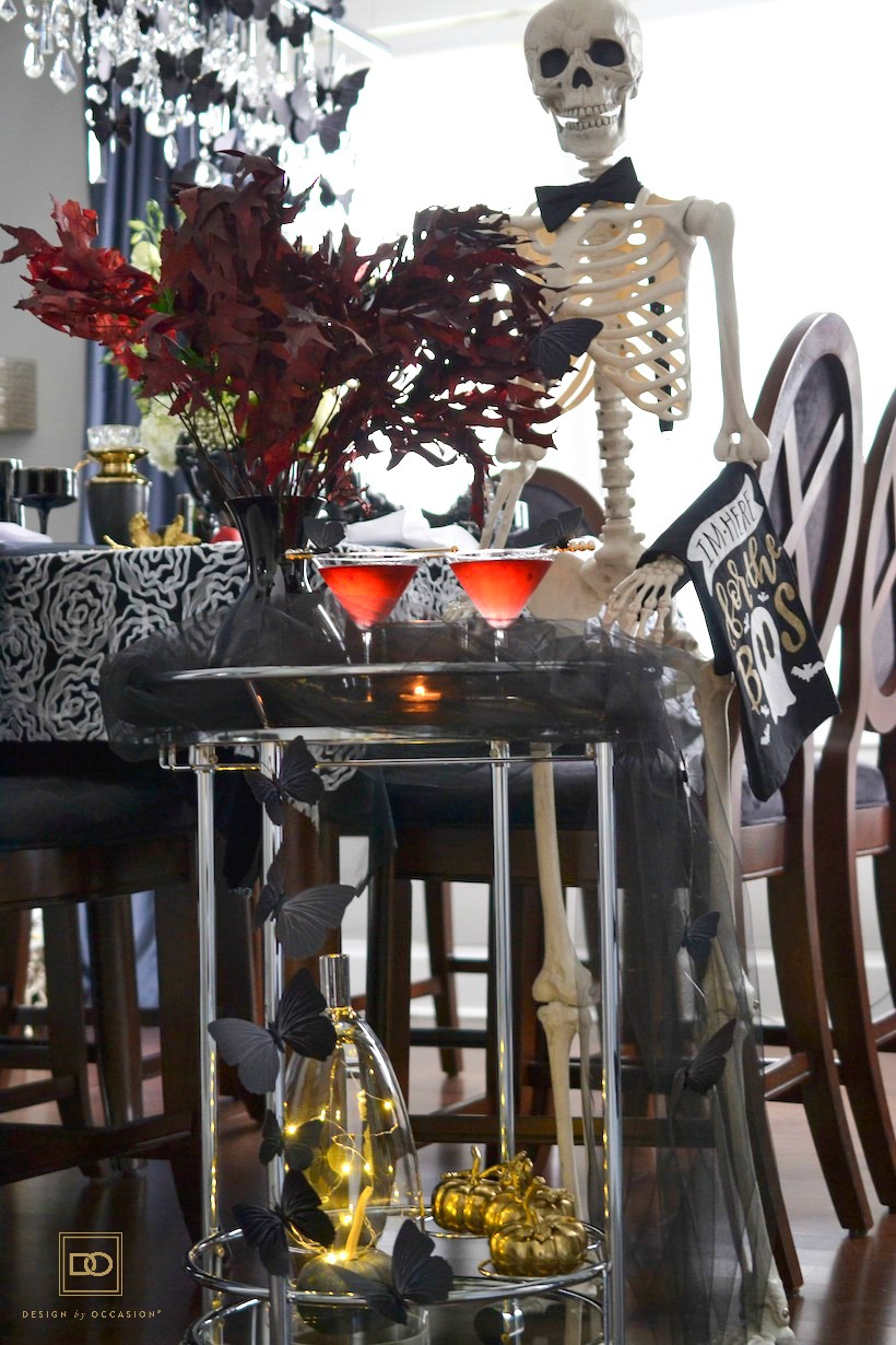 halloween cocktail recipe and a halloween decorated bar cart with a skeleton as your server